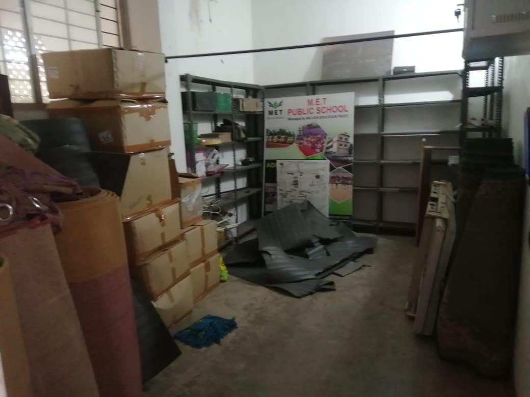 The Book Room as it was: stored boxes, rolled carpets and old shelving