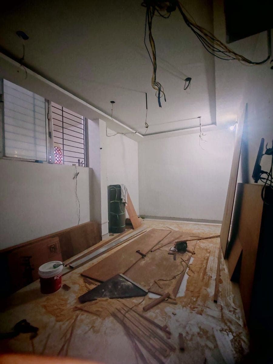 Plywood sheets and timber being cut on the floor of the room